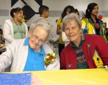 Bernadine Sitts (left) with her sister, celebrating her birthday with students at the Bernadine Sitts Intermediate Center